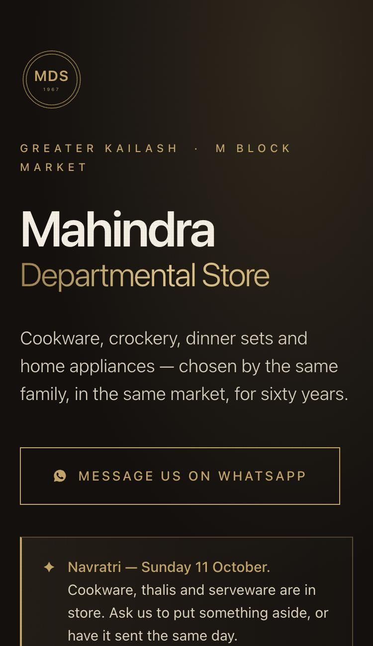 The Mahindra Departmental Store website on a phone: hero with 'Since 1967', what the shop stocks, and a WhatsApp button.